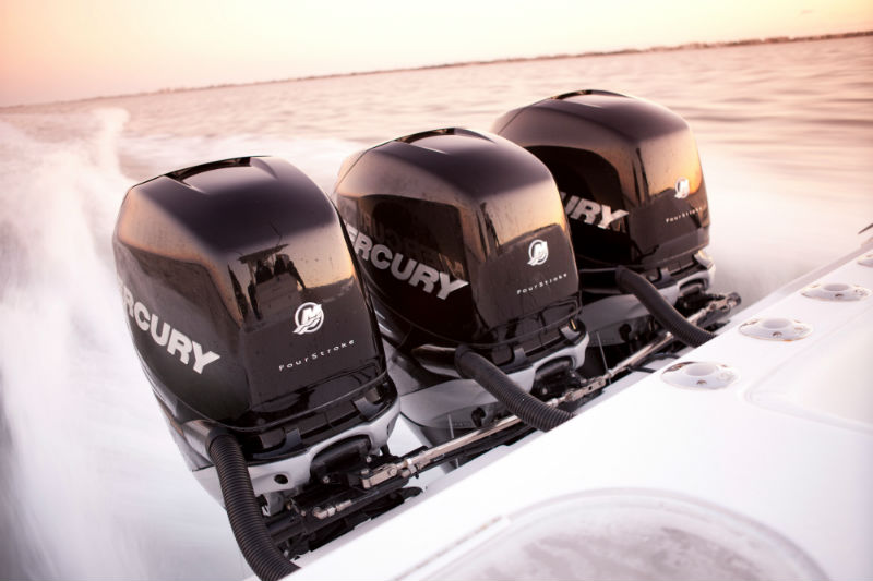 Three Mercury outboard motors on a boat.